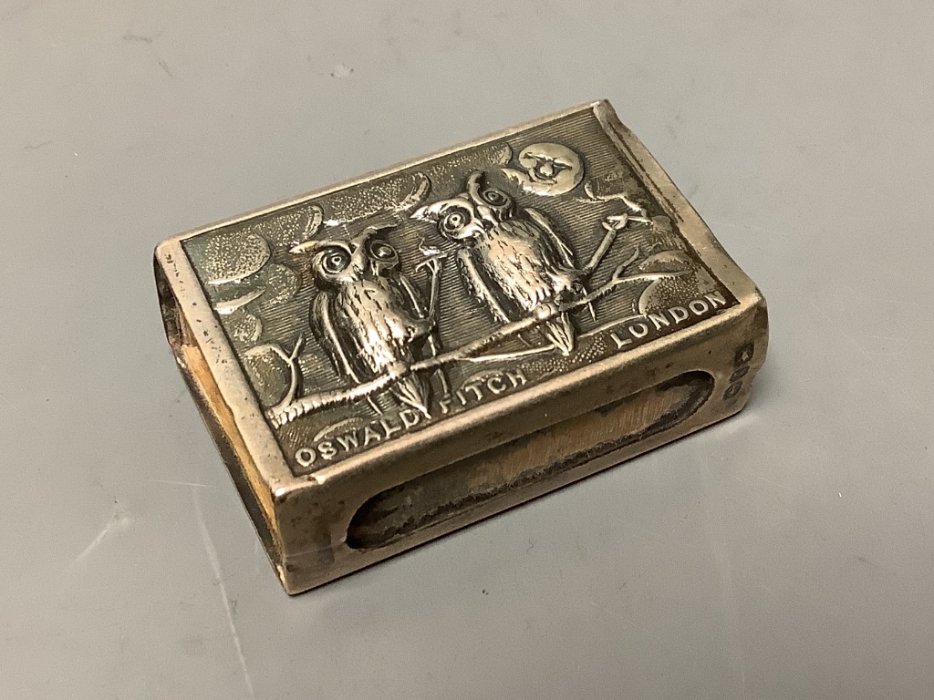 A late Victorian silver matchbox holder, embossed with two owls and inscribed 'Oswald Fitch, London', Birmingham, 1897, 42mm.